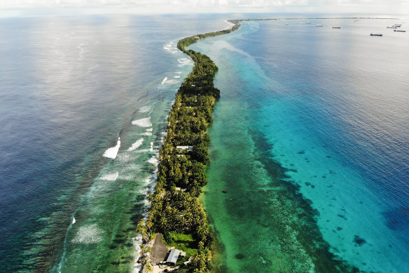 A strip of land between the Pacific Ocean, left, and lagoon in Funafuti, Tuvalu. The low-lying South Pacific island nation of about 12,000 people has been classified as ‘extremely vulnerable’ to climate change by the UN.